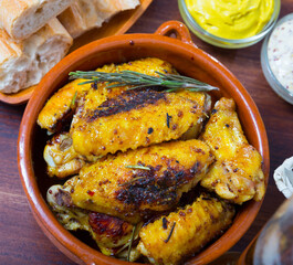 Delicious roasted chicken wings in clayware with delicate mustard dipping sauce....