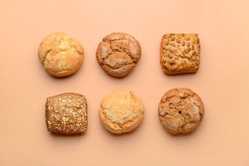 Different delicious buns on beige background