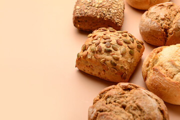 Different delicious buns on beige background