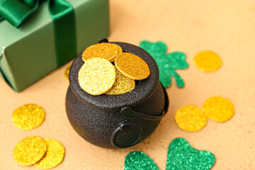 Leprechaun pot with golden coins and clover leaves on beige background. St. Patrick's Day...