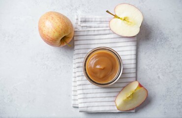 Apple puree in a glass on a white background