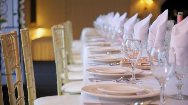 Wedding decor set up catering dinner dish event. fine setting table row chair 