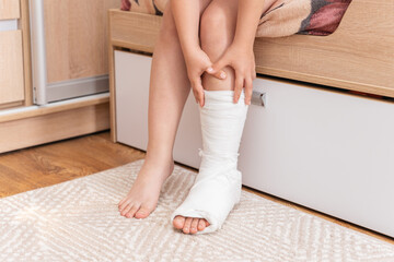 Children's legs, one leg is broken and in a cast