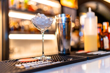 Cocktail glass and shaker in the counter of a bar
