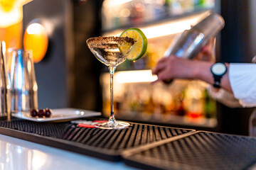 Bartender preparing a luxury cocktail in a martini glass