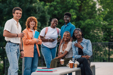 Portrait of diverse college students taking a coffee break at campus.