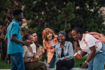 Smiling diverse students on a break with coffee having fun at campus.