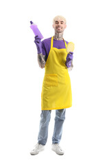 Young tattooed man with bottle of detergent and cleaning sponge on white background