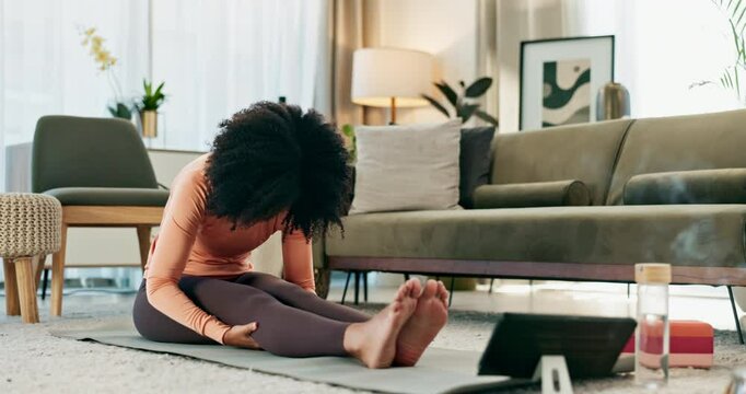 Online yoga class, tablet and woman stretching on floor of living room in home for fitness, health or wellness. Relax, exercise and technology with person in apartment for holistic training or zen