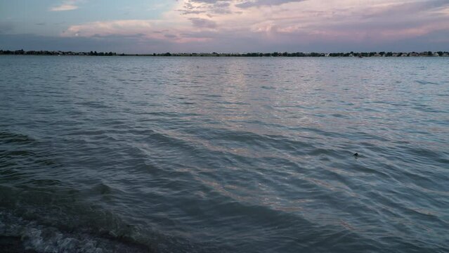Boyd Lake in northern Colorado at dusk with distant boats and jetski passing, background plate