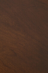 Dark walnut wood grain texture. Vertical wood pattern banner photograph.
