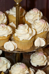 Cupcakes with frosting on a tiered display. 