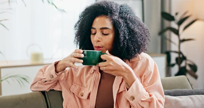 Black woman, relax and smelling coffee with aroma for caffeine, hot beverage or latte on sofa at home. Calm African or young female person enjoying morning drink, cappuccino or warm scent at house