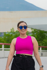 Smiling Latin Young Woman in Sportswear Outdoors