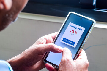 Person using smartphone to subscribe package plan using mobile applications. Selective focus.