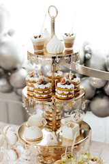 A dessert table with a variety of desserts including cakes, cupcakes