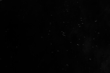 Abstract oxygen bubbles in the sea.Air bubbles in the water background.Water bubbles isolate on black background.Black and white tone style.