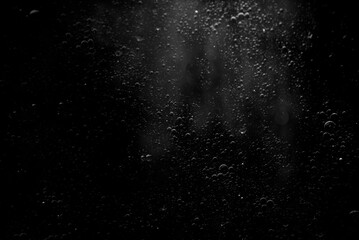 Abstract oxygen bubbles in the sea.Air bubbles in the water background.Water bubbles isolate on black background.Black and white tone style.