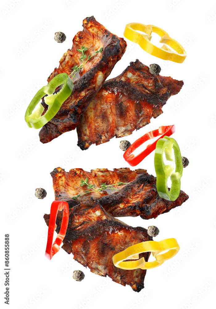 Wall mural grilled beef ribs, pepper slices and peppercorns in air isolated on white