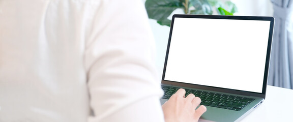 Woman using laptop computer with blank screen for mock up template background, people business technology and lifestyle background concept