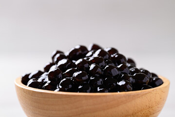 Black tapioca pearls or boba in wooden bowl, Ingredient in bubble tea