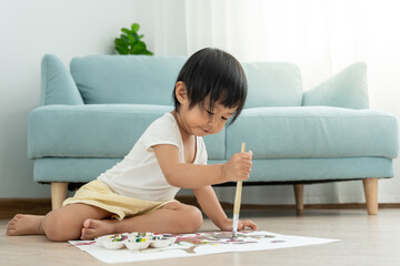 Happy Asia mother learning paint for little girl. family is happy and excited in the house. Mother and daughter having fun spending time together. Holiday, Activity, Executive Function, IQ, EQ.