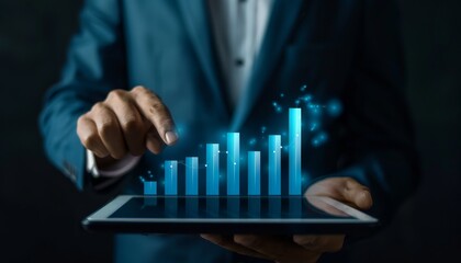 Businessman using tablet with rising bar chart
