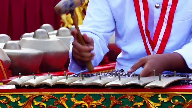 Indonesians are playing one of the traditional instruments from Java
