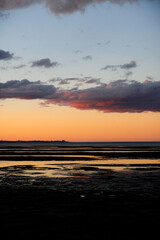 Orange sunset on the beach with low tide