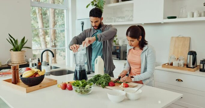 Blender, juice and couple with healthy food for diet, detox and breakfast drink in kitchen at home. Vegan nutritionist or man and woman helping with vegetables to prepare ingredients for smoothie