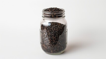 Black Rice in a Glass Jar on a White Background