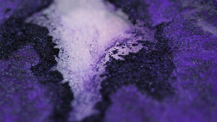 Sparkling paint. Wet glitter texture. Defocused purple black color shimmering sand particles glow liquid gloss pigment mix ink fluid spill abstract art background.