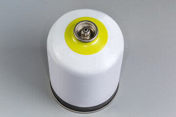 Disposable metal gas cartridge for camp stove on gray background