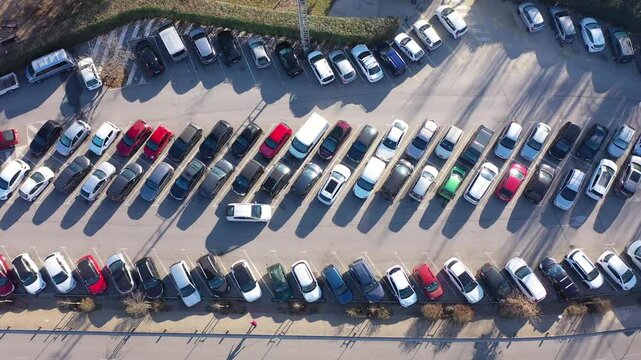 bird's-eye view of car rows at crowded parking lot. High quality 4k footage