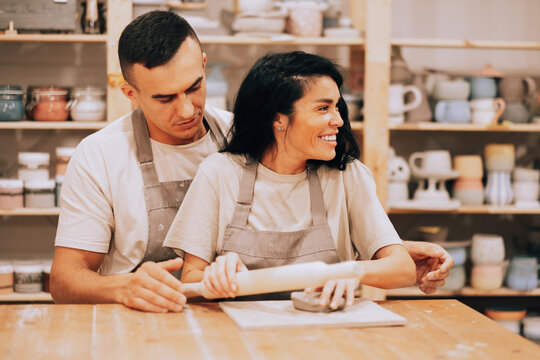 A young couple is engaged in creativity in a pottery workshop