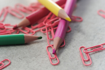 Pencils in different colors and clips on light background