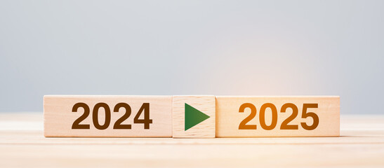 2025 and 2024 wooden block on table background. Resolution, strategy, countdown, goal, change and...