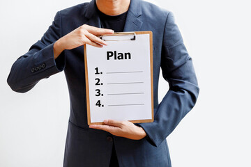 Business Planning concept; Business man holding plan list on clipboard