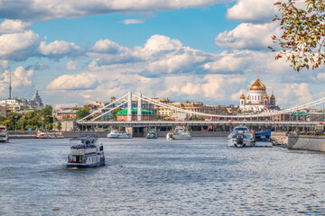Obraz premium Cruise ship sails on the Moscow river in Moscow city center, popular place for walking.