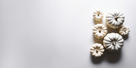 Small white pumpkins on a white background, creating a minimalist and clean composition, flat lay thanksgiving concept, top view with copy space