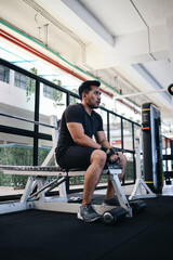 Portrait of muscular man at sport club gym. Healthy lifestyle concept.