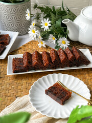 Kek Buah Kukus, a traditional Malaysian steamed fruit cake filled with dried fruits, nuts, and spices, enjoyed during celebrations.