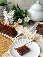 Kek Buah Kukus, a traditional Malaysian steamed fruit cake filled with dried fruits, nuts, and spices, enjoyed during celebrations.
