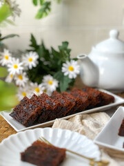 Kek Buah Kukus, a traditional Malaysian steamed fruit cake filled with dried fruits, nuts, and spices, enjoyed during celebrations.