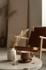 Cup of coffee standing on table in minimalist interior design