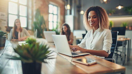 Fototapeta premium A woman is sitting at a table with a laptop, creating a pleasant and relaxing atmosphere.