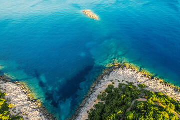 Lighthouse on the cliff. Seascape of Cape Lefkatas with old lighthouse on Lefkada island, Greece. Beautiful views of azure sea water and nature with cliffs