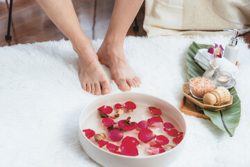 Woman indulges in blissful foot massage at luxurious spa salon while masseur give reflexology...