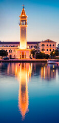 Fototapeta premium Picturesque spring sunset in the Zakynthos city. Great evening view of the town hall and Saint Dionysios Church, Ionian Sea, Zakynthos island, Greece, Europe. Traveling concept background.