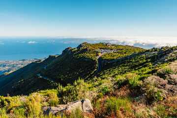 Hiking on the highest peak of Madeira Pico Ruivo next to the cottage Abrigo do Pico Ruivo. Views of...